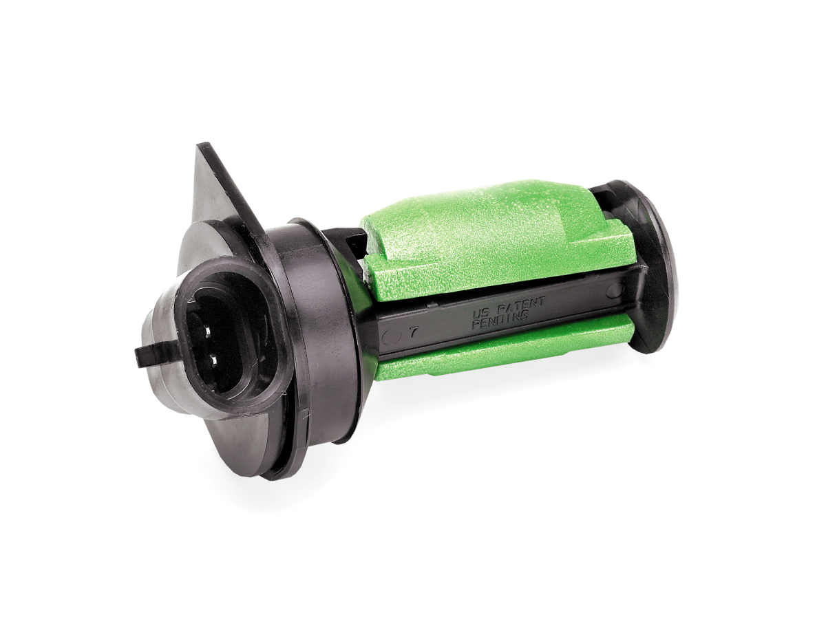 A green and black plastic electrical connector from the R12431 Series, featuring a cylindrical body and flanged end, used for wiring or Liquid Level Sensor applications, shown against a white background. by Standex Detect