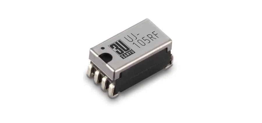 A close-up of a small electronic component, likely an integrated circuit from Standex Electronics, with a metallic top marked 3U SAKYU JU 105RF and four pins on each side, ideal for high-voltage reed relays and peak testing standards. by Standex Detect