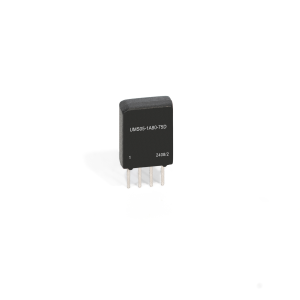 A small black Reed Relay electronic component from the UMS Series with four metal pins and the label UM505-1A80-75D 24082 printed on its front, standing upright on a white background. by Standex Detect