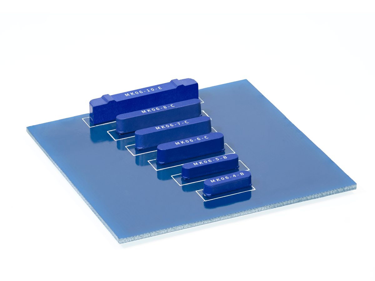 A blue square glass panel features six blue rectangular blocks, including the MK06 Series Reed Switch, each labeled with different codes and arranged in descending order of size, placed diagonally across the panel on a white background. by Standex Detect