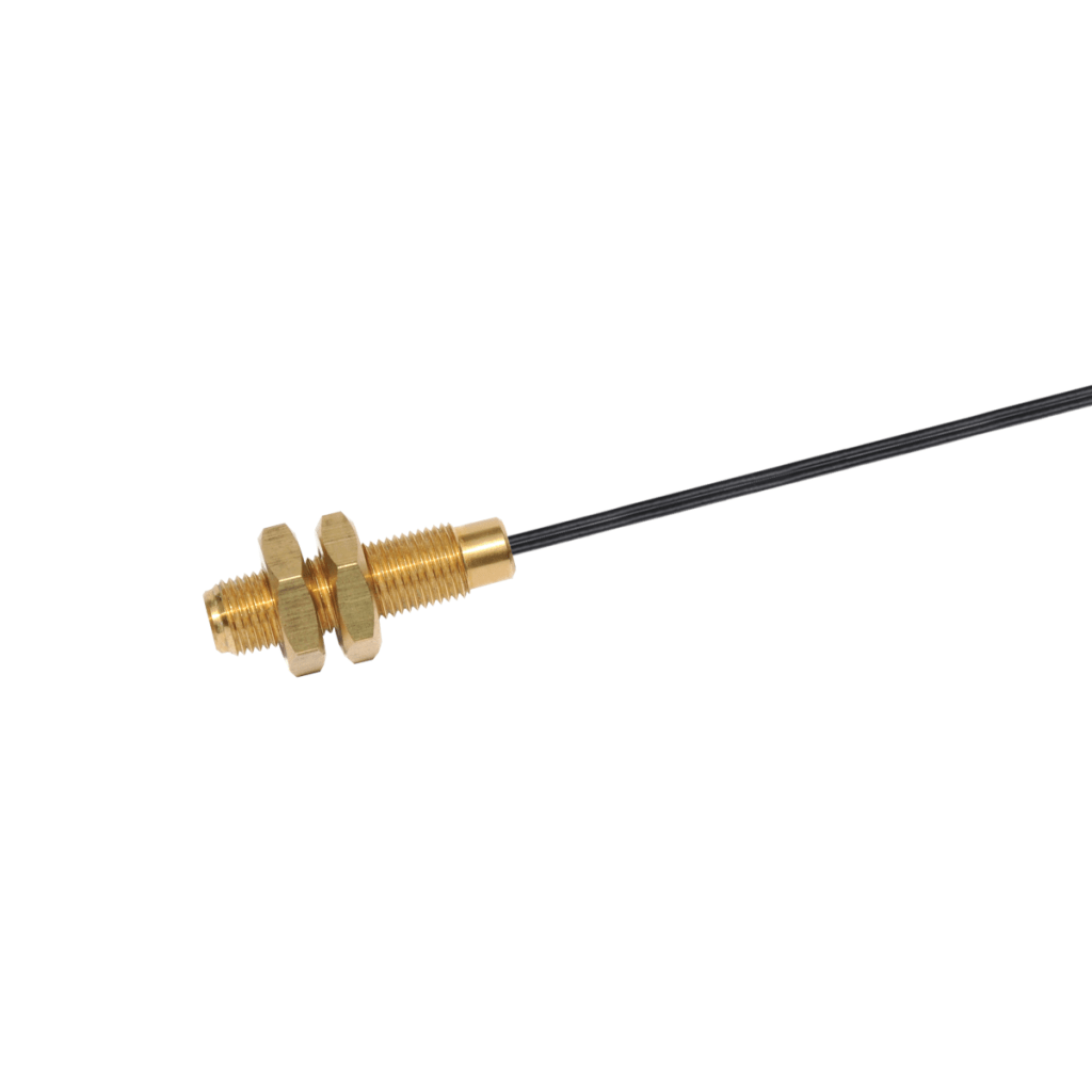 Close-up of a Brass Series MK11 reed sensor with two hex nuts and a black cable extending from one end, isolated on a white background. by Standex Detect