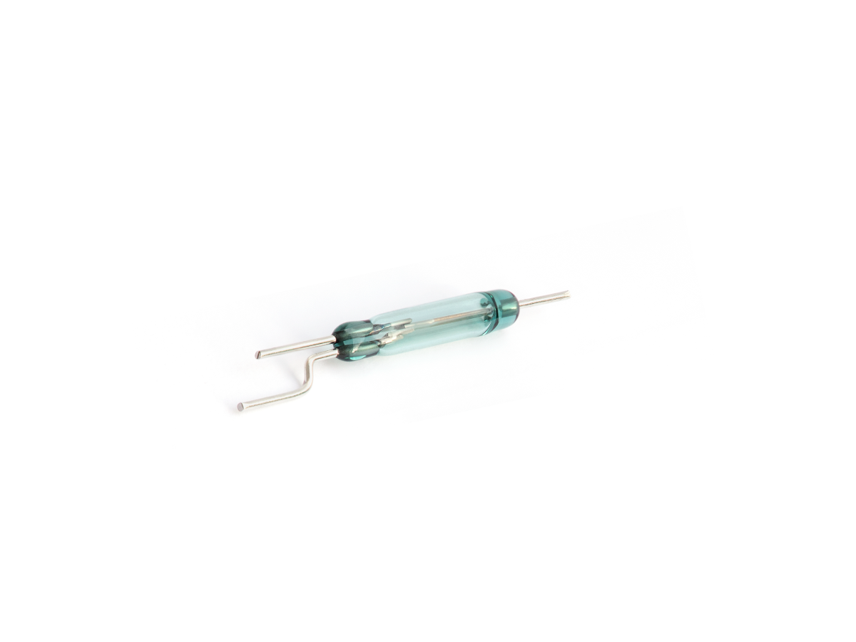 A small glass Reed Switch with metal leads extending from both ends, one of which is bent, isolated on a white background. Ideal for MK23-90 Series applications. by Standex Detect