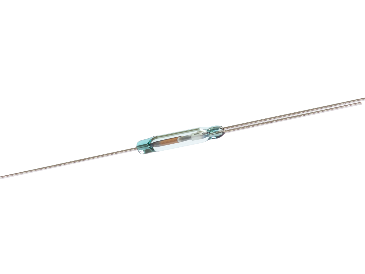 A small ORT551 Reed Switch with metal leads extending from both ends is displayed on a white background. The cylindrical glass body of this reed switch encloses thin metal contacts inside. by Standex Detect